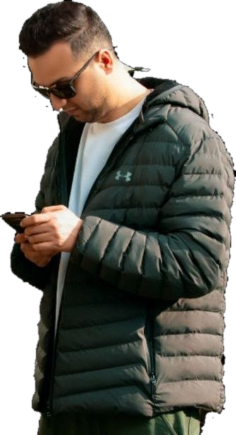 Aref in sunglasses, a white T-shirt and a dark green puffer jacket, looking down at his phone